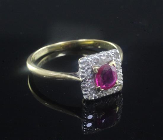 An early 20th century 18ct gold and platinum, ruby and diamond cluster ring, size P.